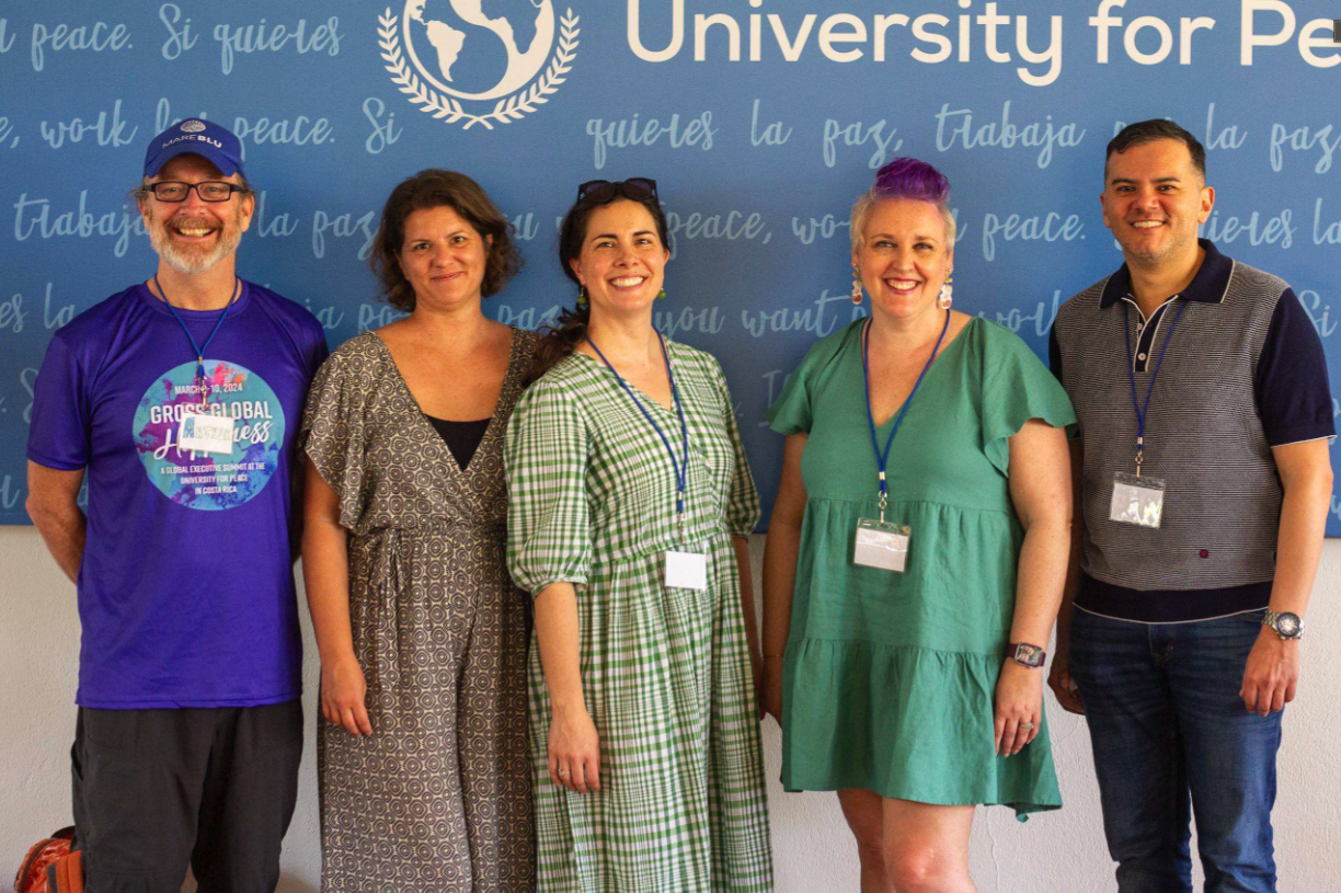 Five smiling members of the GGH community at the University for Peace